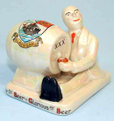 Carlton Ware Heraldic China model<br />
					of a man sitting next to a beer barrel.